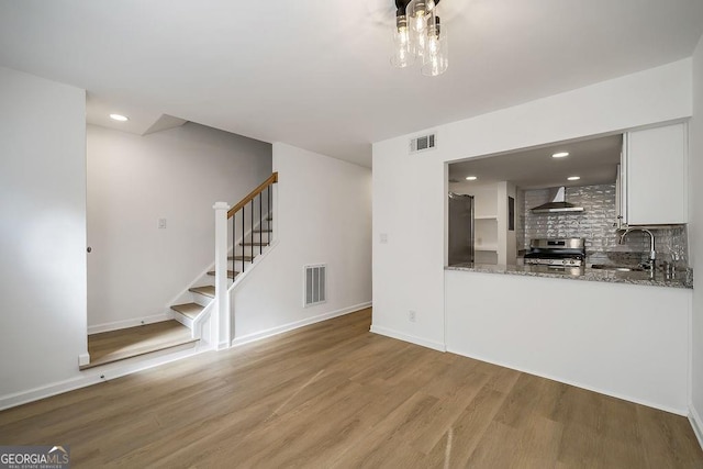 510 Northridge Crossing Dr, Sandy Springs, GA 30350 - unfurnished living room with wood finished floors, stairway, a sink, baseboards, and recessed lighting