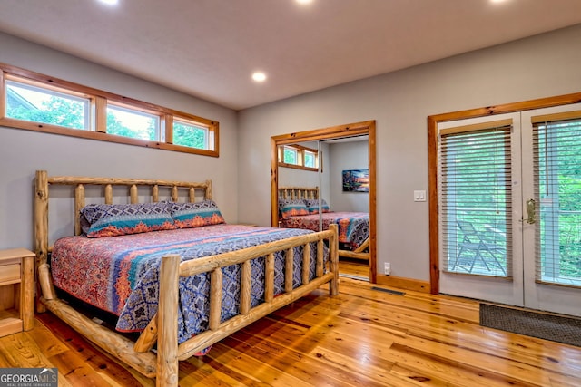 bedroom with hardwood / wood-style flooring, recessed lighting, and access to outside