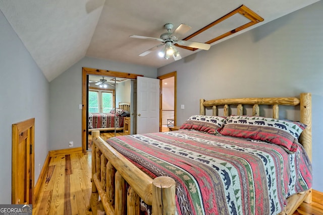 bedroom with wood finished floors, vaulted ceiling, ceiling fan, and baseboards