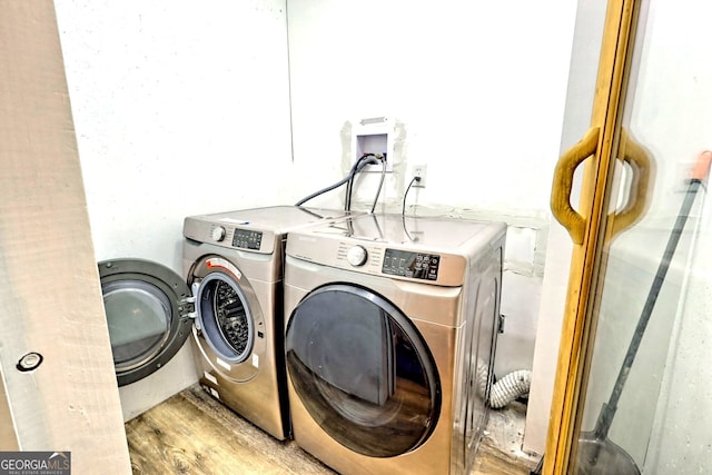 washroom featuring washer and dryer and light wood-style flooring
