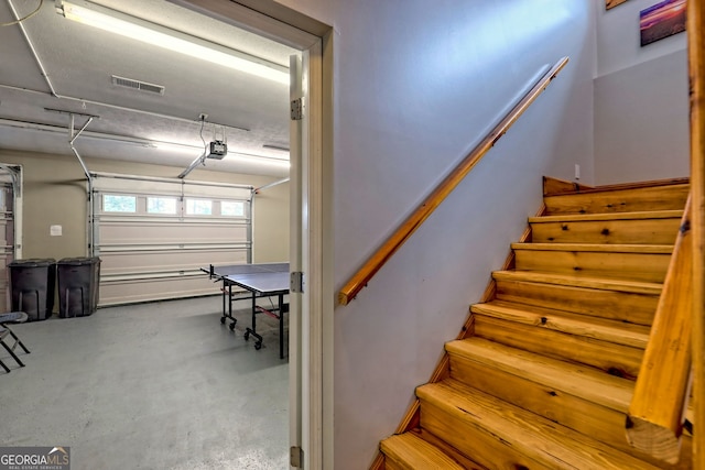 stairway featuring concrete floors