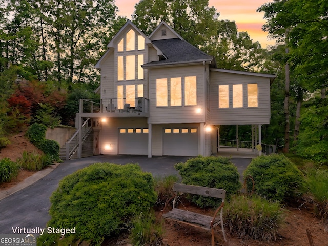 view of front of home featuring stairway, driveway, and a garage