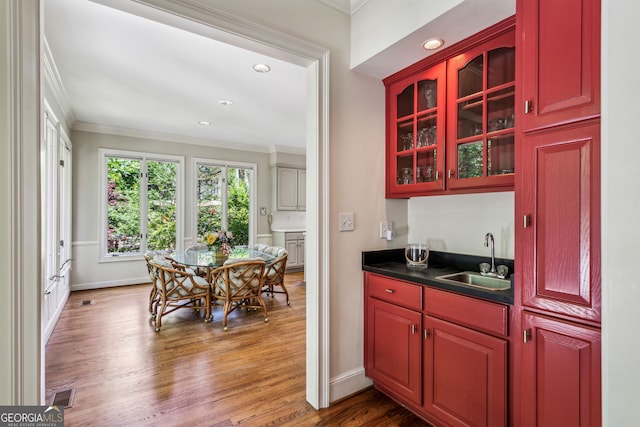 4070 Ridgehurst Dr SE, Smyrna, GA 30080 - indoor wet bar with crown molding, wood finished floors, baseboards, and recessed lighting