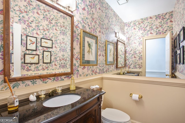 4070 Ridgehurst Dr SE, Smyrna, GA 30080 - half bath featuring wallpapered walls, toilet, and vanity