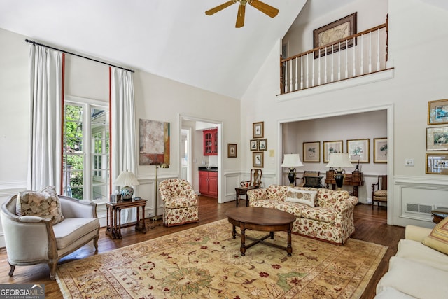 4070 Ridgehurst Dr SE, Smyrna, GA 30080 - living room featuring high vaulted ceiling, a ceiling fan, wood finished floors, a decorative wall, and a wainscoted wall