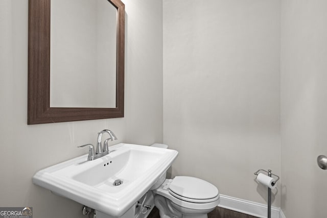896 Farmstead Rd Unit 162, Suwanee, GA 30024 - half bath featuring a sink, toilet, and baseboards