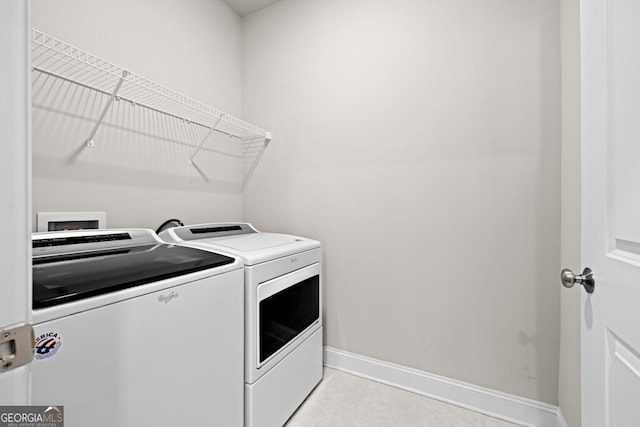 896 Farmstead Rd Unit 162, Suwanee, GA 30024 - clothes washing area featuring washing machine and clothes dryer, baseboards, and light tile patterned flooring