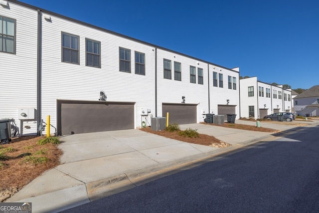 896 Farmstead Rd Unit 162, Suwanee, GA 30024 - view of front of home featuring a garage, driveway, central AC, and a residential view
