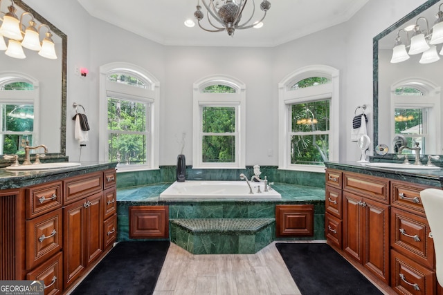 364 Osprey Cir, Saint Marys, GA 31558 - full bathroom with a chandelier, two vanities, a garden tub, wood finished floors, and ornamental molding
