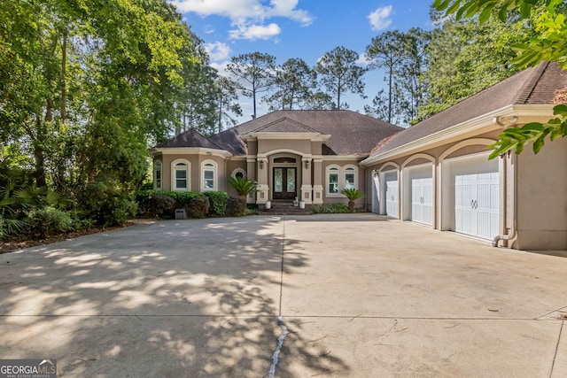 364 Osprey Cir, Saint Marys, GA 31558 - mediterranean / spanish home with french doors, stucco siding, concrete driveway, and a garage