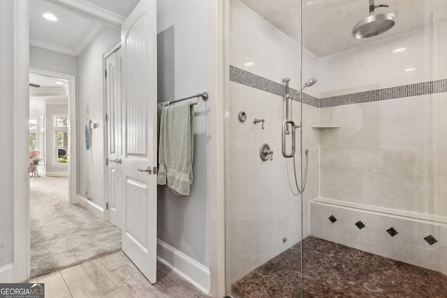 364 Osprey Cir, Saint Marys, GA 31558 - bathroom featuring tiled shower, ornamental molding, baseboards, and wood finished floors