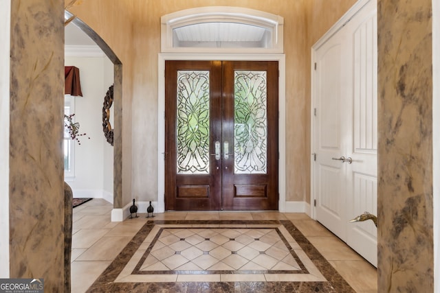 364 Osprey Cir, Saint Marys, GA 31558 - foyer featuring inlaid floor details, french doors, baseboards, and arched walkways