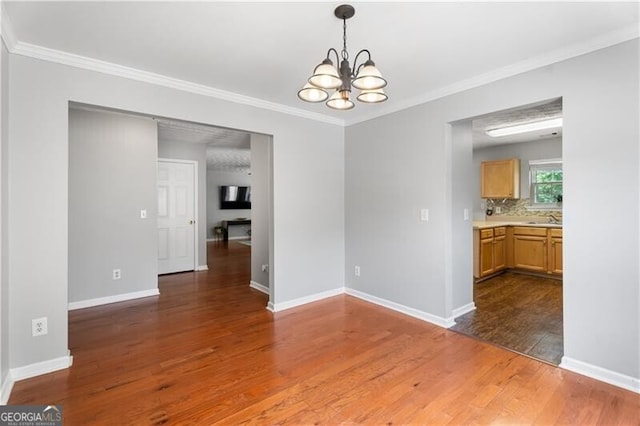 411 Sugar Maple Ct, Canton, GA 30114 - spare room featuring a chandelier, wood finished floors, ornamental molding, baseboards, and a sink