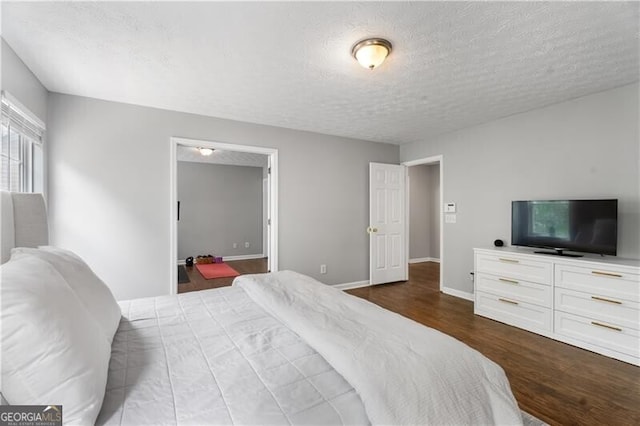 411 Sugar Maple Ct, Canton, GA 30114 - bedroom featuring wood finished floors, a textured ceiling, and baseboards