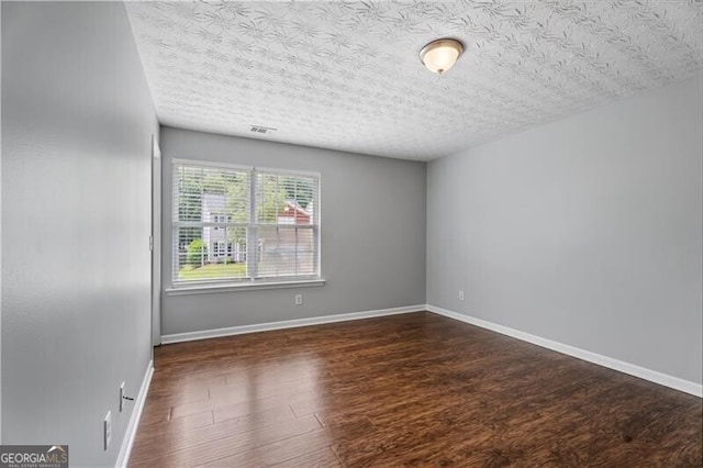 411 Sugar Maple Ct, Canton, GA 30114 - empty room with a textured ceiling, wood finished floors, and baseboards
