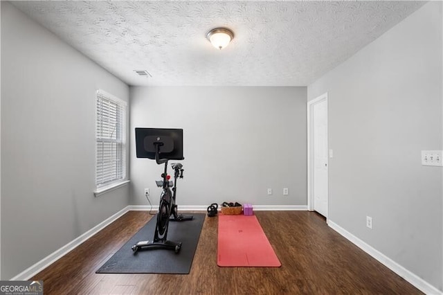 411 Sugar Maple Ct, Canton, GA 30114 - workout area featuring wood finished floors, baseboards, and a textured ceiling