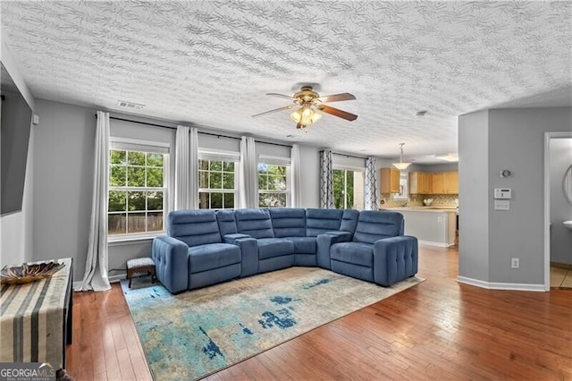 411 Sugar Maple Ct, Canton, GA 30114 - living area featuring a ceiling fan, hardwood / wood-style flooring, a textured ceiling, and baseboards