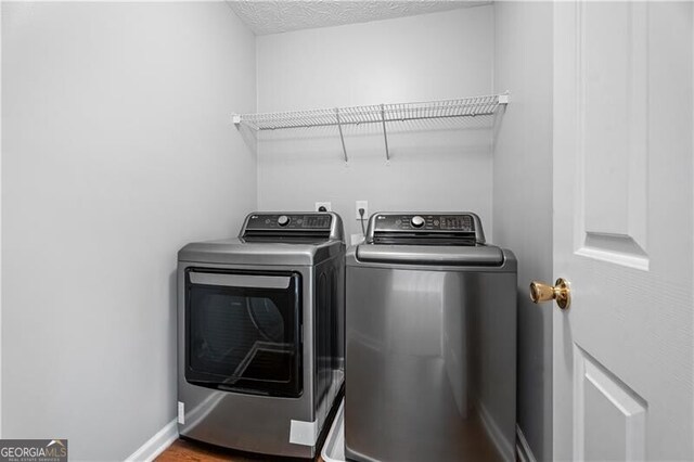 411 Sugar Maple Ct, Canton, GA 30114 - laundry area featuring washer and dryer, baseboards, and wood finished floors