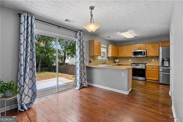 411 Sugar Maple Ct, Canton, GA 30114 - kitchen featuring stainless steel appliances, decorative backsplash, dark wood-type flooring, and a textured ceiling