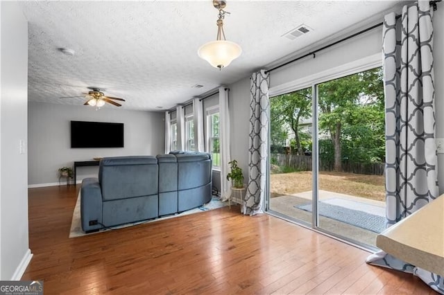 411 Sugar Maple Ct, Canton, GA 30114 - living room with hardwood / wood-style flooring, a textured ceiling, a ceiling fan, and baseboards