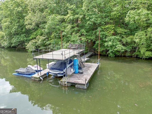dock area featuring a water view and stairway