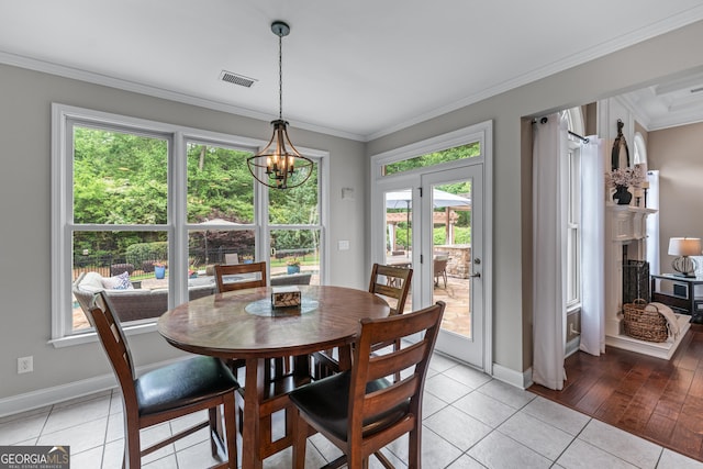 1610 Turtle Pond Dr, Hoschton, GA 30548 - dining space featuring plenty of natural light, light tile patterned floors, ornamental molding, and a chandelier