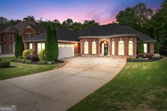 1610 Turtle Pond Dr, Hoschton, GA 30548 - view of front of property featuring concrete driveway, brick siding, a garage, and a front lawn