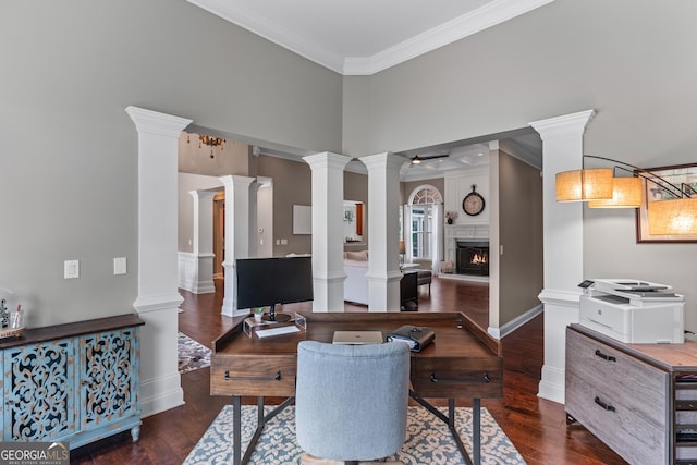 1610 Turtle Pond Dr, Hoschton, GA 30548 - office area with a warm lit fireplace, ornamental molding, decorative columns, wood finished floors, and a towering ceiling
