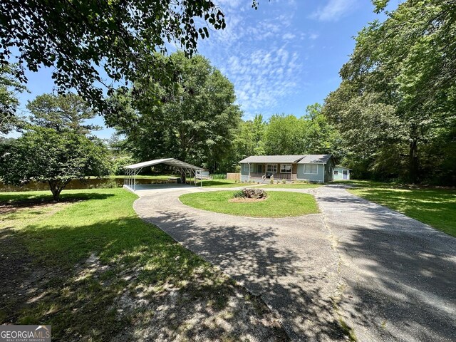 485 Angham Rd, Hiram, GA 30141 - view of front of house featuring a carport, a front lawn, and driveway