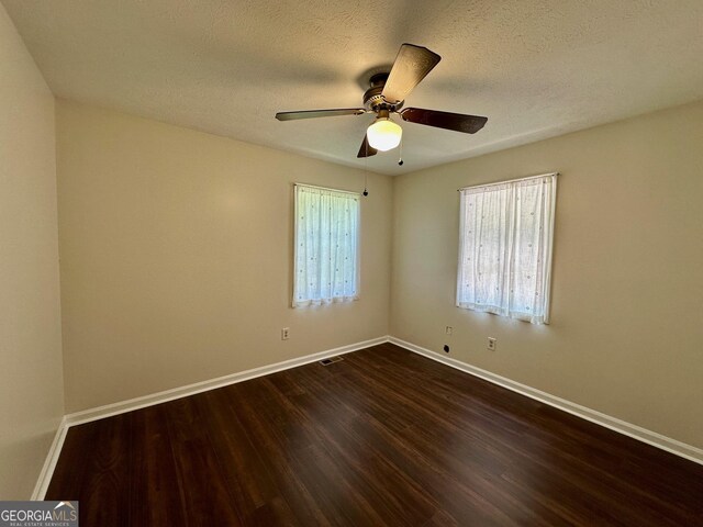485 Angham Rd, Hiram, GA 30141 - unfurnished room with dark wood-style floors, a ceiling fan, and a textured ceiling