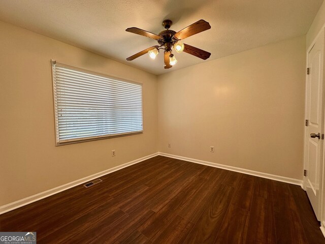 485 Angham Rd, Hiram, GA 30141 - unfurnished room with dark wood-style flooring, a ceiling fan, and a textured ceiling