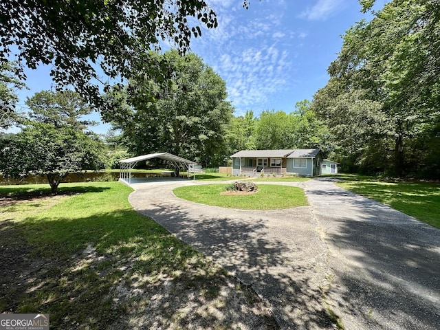 485 Angham Rd, Hiram, GA 30141 - view of front of home featuring a detached carport, a front yard, and driveway