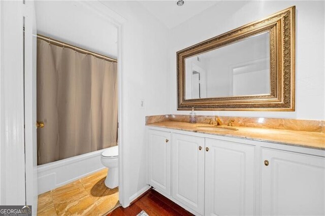 52 Chaumont Sq NW, Atlanta, GA 30327 - bathroom featuring vanity, toilet, and shower / bath combo with shower curtain
