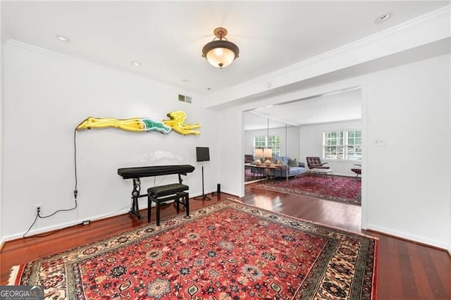 52 Chaumont Sq NW, Atlanta, GA 30327 - living area with wood finished floors, crown molding, and baseboards