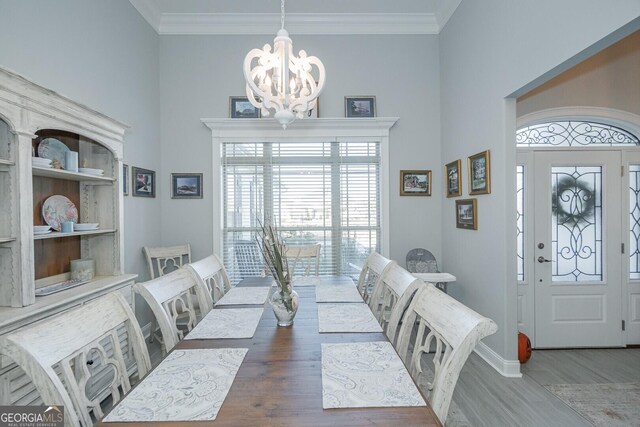 216 Jake Colton Dr, Kingsland, GA 31548 - dining space with wood finished floors, a chandelier, plenty of natural light, baseboards, and ornamental molding