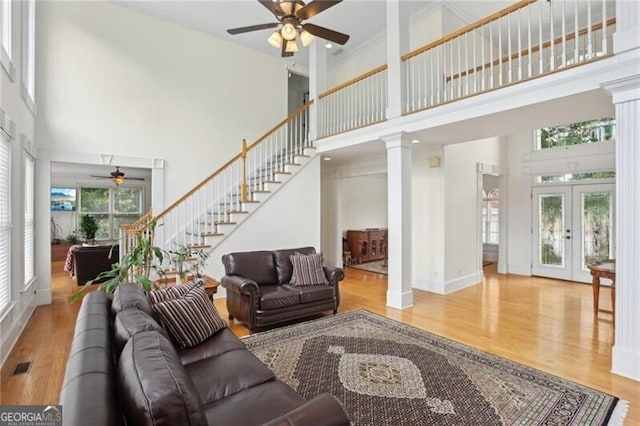 1029 Ector Dr NW, Kennesaw, GA 30152 - living area with ceiling fan, a high ceiling, stairway, and wood finished floors
