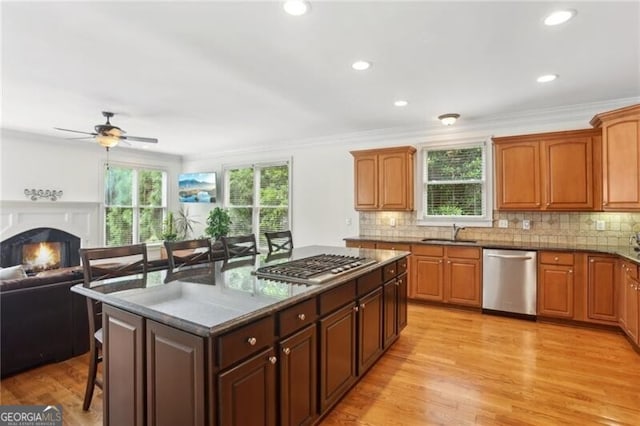 1029 Ector Dr NW, Kennesaw, GA 30152 - kitchen with appliances with stainless steel finishes, a sink, open floor plan, a breakfast bar area, and a ceiling fan