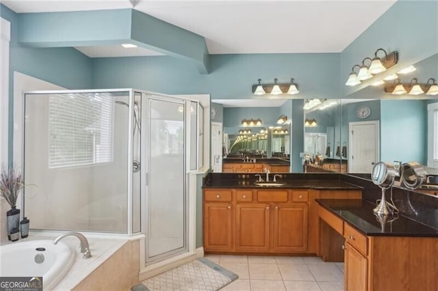 1029 Ector Dr NW, Kennesaw, GA 30152 - bathroom with tile patterned floors, a stall shower, a garden tub, vanity, and plenty of natural light