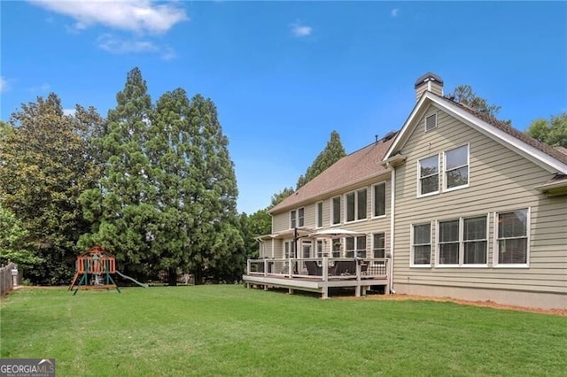 1029 Ector Dr NW, Kennesaw, GA 30152 - rear view of house featuring a playground, a yard, a wooden deck, and a chimney
