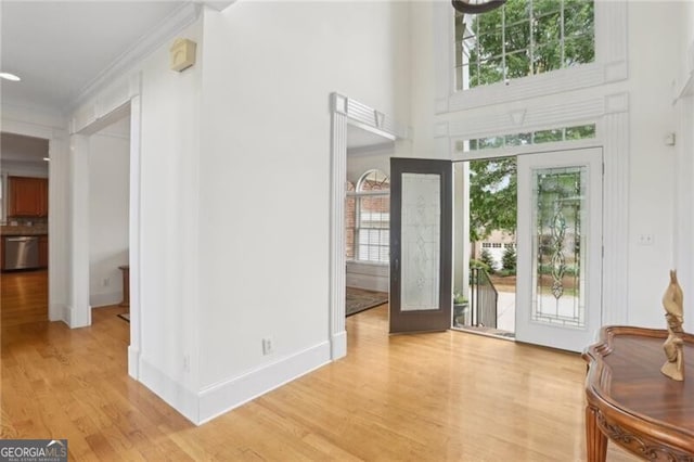 1029 Ector Dr NW, Kennesaw, GA 30152 - entrance foyer with plenty of natural light, light wood-style floors, ornamental molding, and baseboards