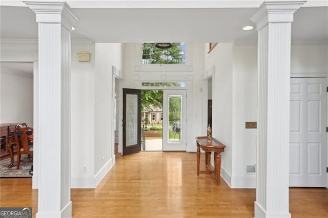 1029 Ector Dr NW, Kennesaw, GA 30152 - foyer entrance featuring ornate columns, wood finished floors, ornamental molding, and baseboards