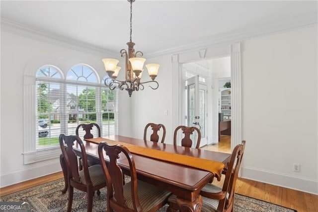 1029 Ector Dr NW, Kennesaw, GA 30152 - dining room featuring a chandelier, plenty of natural light, ornamental molding, and baseboards
