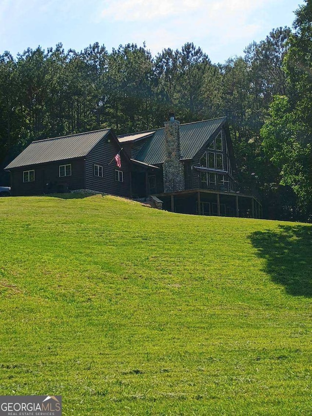 601 Colquitt Rd, Cedartown, GA 30125 - view of front of home featuring a chimney, a front yard, and metal roof