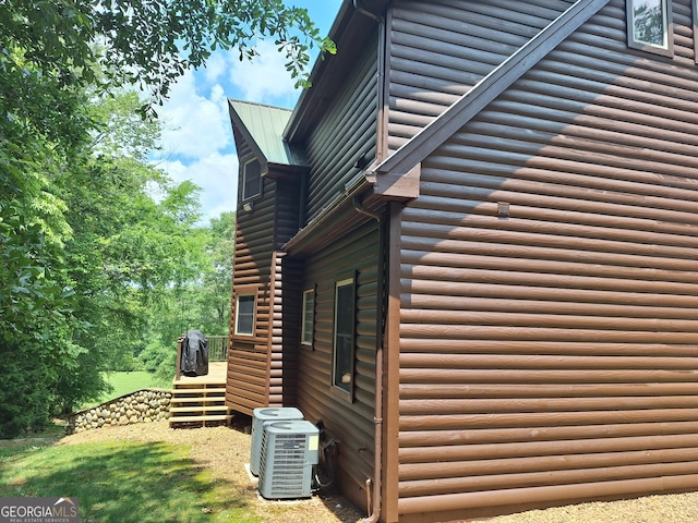 601 Colquitt Rd, Cedartown, GA 30125 - view of home's exterior with central AC, log veneer siding, and a deck