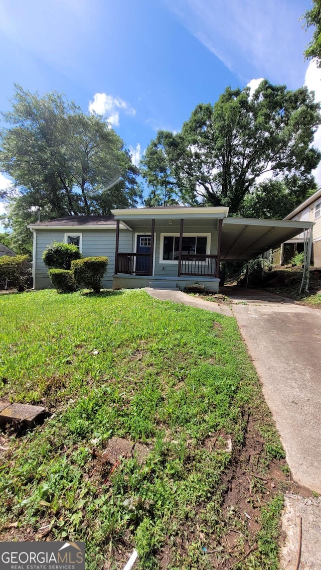 214 Upshaw St SW, Atlanta, GA 30315 - manufactured / mobile home with concrete driveway, covered porch, an attached carport, and a front yard