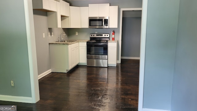 214 Upshaw St SW, Atlanta, GA 30315 - kitchen with appliances with stainless steel finishes, a sink, baseboards, and dark wood-type flooring
