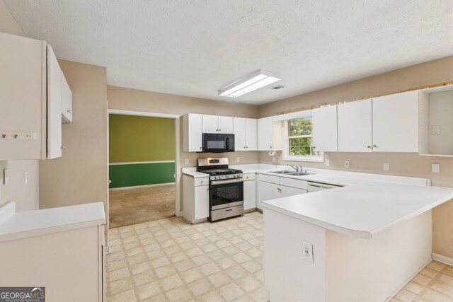 111 Trellis Ct, Acworth, GA 30101 - kitchen featuring stainless steel range with gas cooktop, black microwave, light floors, a sink, and a peninsula