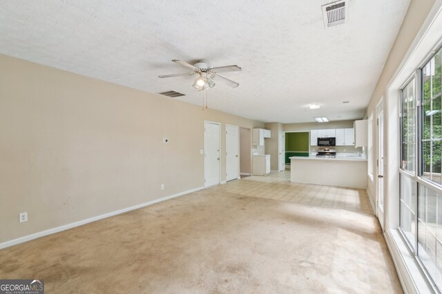 111 Trellis Ct, Acworth, GA 30101 - unfurnished living room featuring baseboards, light colored carpet, ceiling fan, and a textured ceiling
