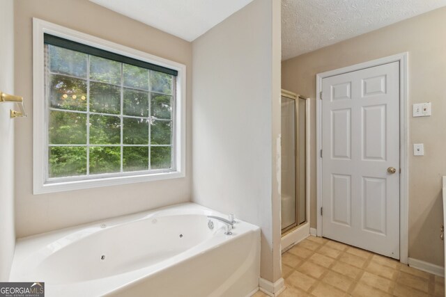 111 Trellis Ct, Acworth, GA 30101 - bathroom featuring a tub with jets, a stall shower, and healthy amount of natural light