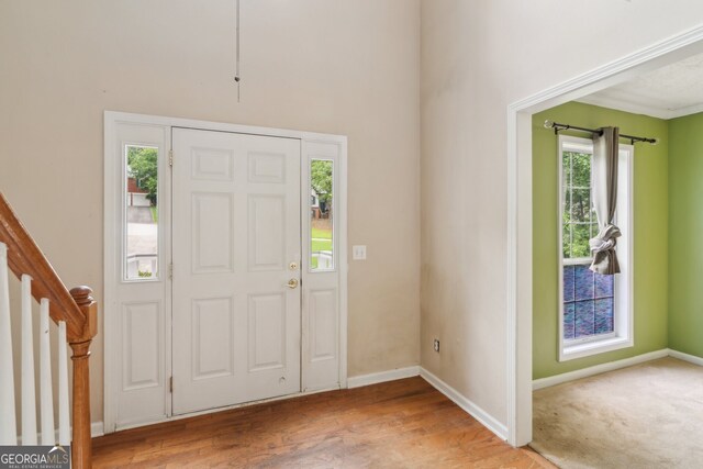 111 Trellis Ct, Acworth, GA 30101 - foyer featuring plenty of natural light, baseboards, wood finished floors, stairs, and a towering ceiling